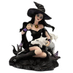Witch and dragon and crystal ball figurine